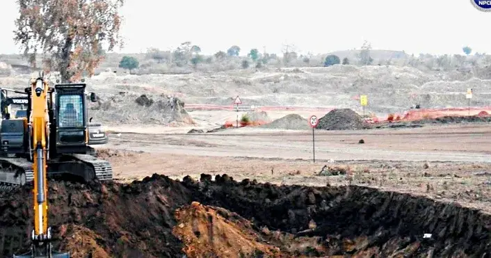 An excavator digging on a cleared, flat site at Mahi Banswara in Rajasthan